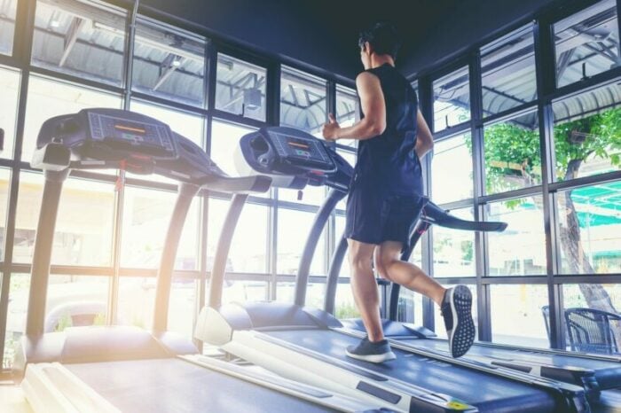 Man running on a treadmill at a gym