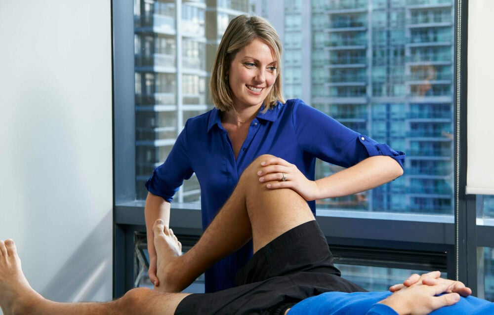 Physiotherapist Courtney Steele performing knee joint mobilization on a patient at Cornerstone Physiotherapy North York