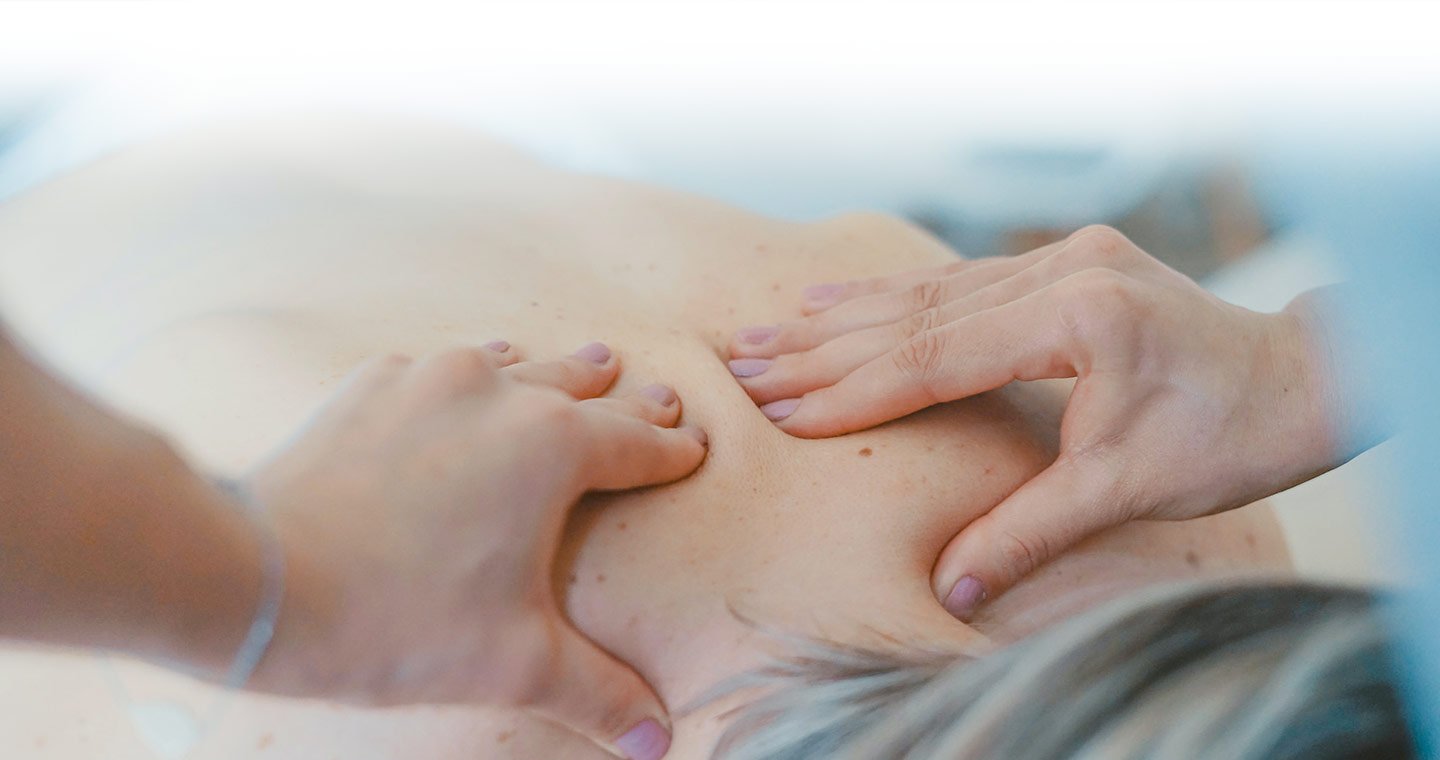 Close up of hands massaging a patients lower neck
