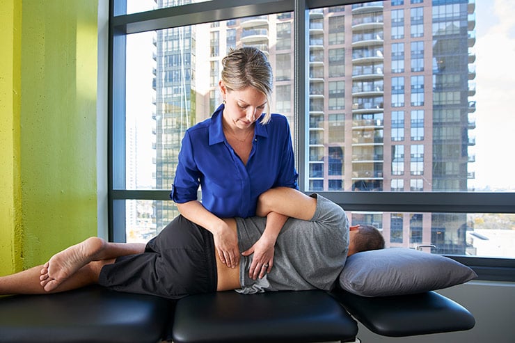 Clinic Director Courtney Steele performing advanced manual therapy techniques to treat low back pain.
