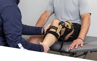 Physiotherapist fitting a custom knee brace