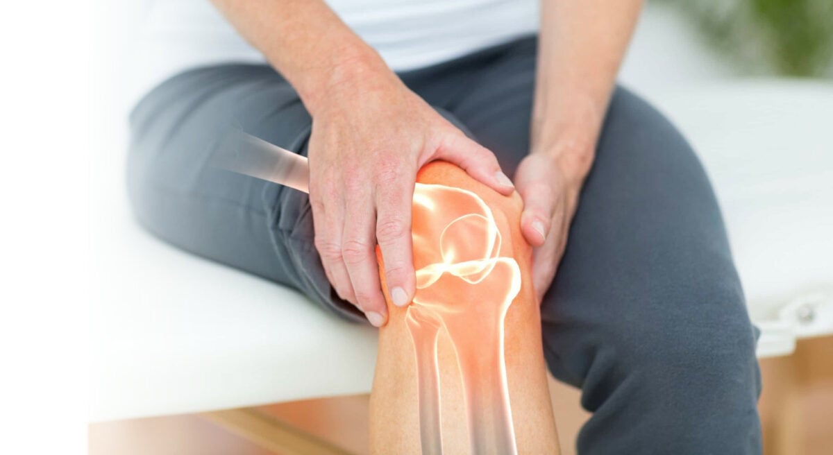 woman holding knee in pain due to osteoarthritis or arthritis