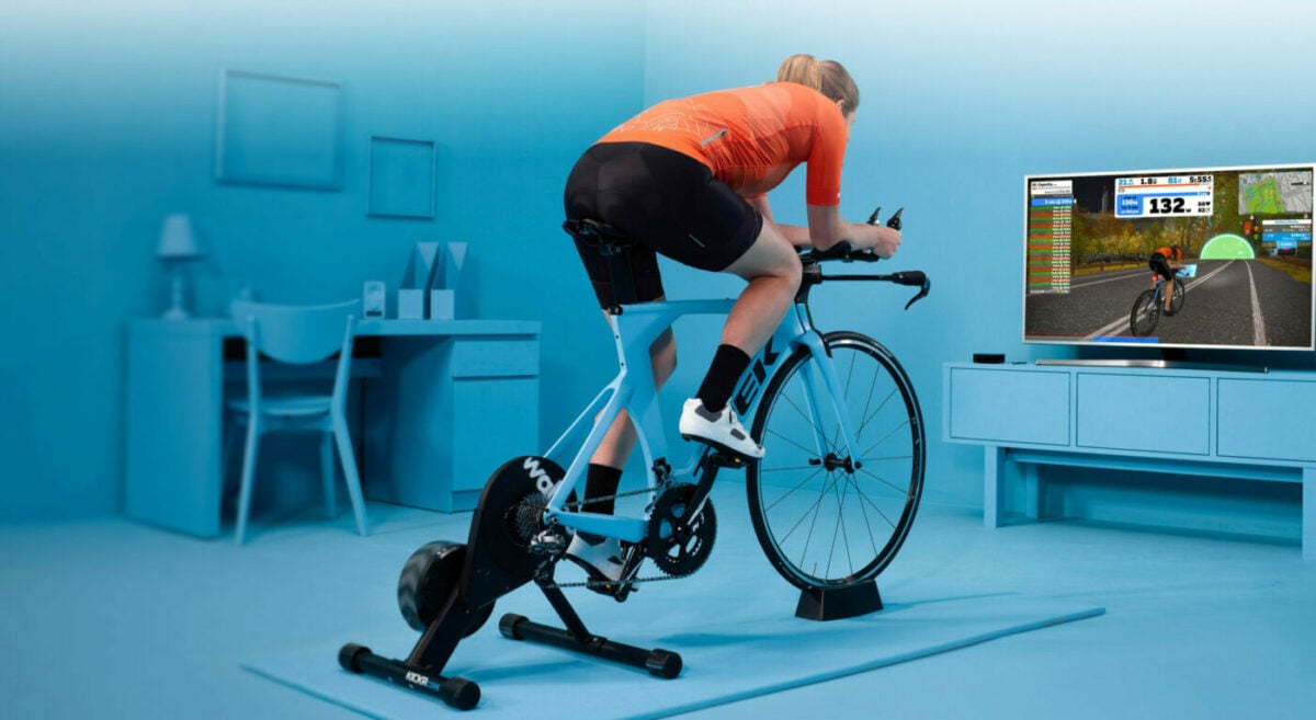 Indoor cycling on a trainer using an workout app on tv screen