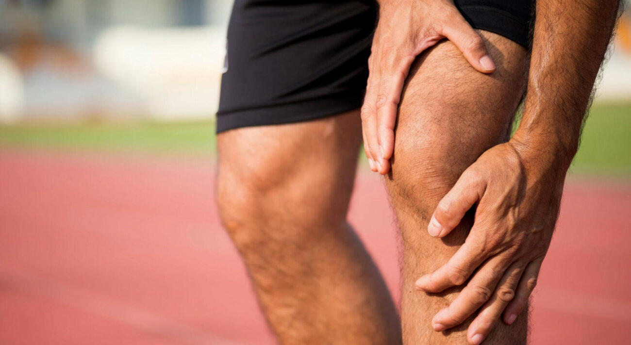 man holding his knee in pain due to runners knee or patellofemoral syndrome