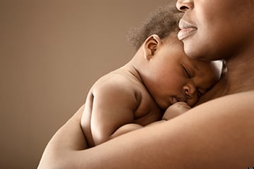 black woman holding newborn baby